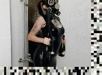 Backstage from the Halloween shoot. Mistress in a gas mask and latex is doused with wine